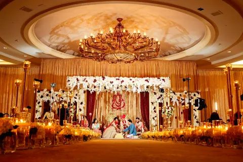 A ceremony under a canopy in a grand hall