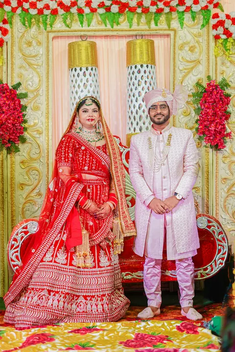 The couple posing on a decorated stage