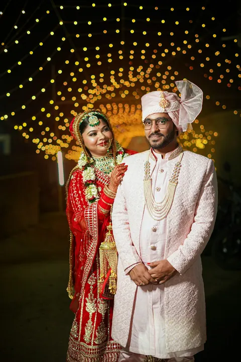Full-length portrait of the couple in their wedding outfits