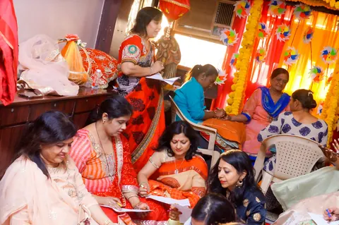 Women gathered together in festive clothes, talking and laughing