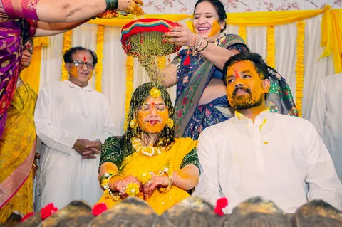 Family seated together during a haldi ceremony