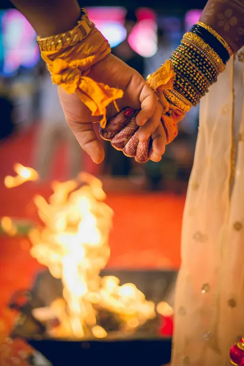 Joined hands above the sacred fire
